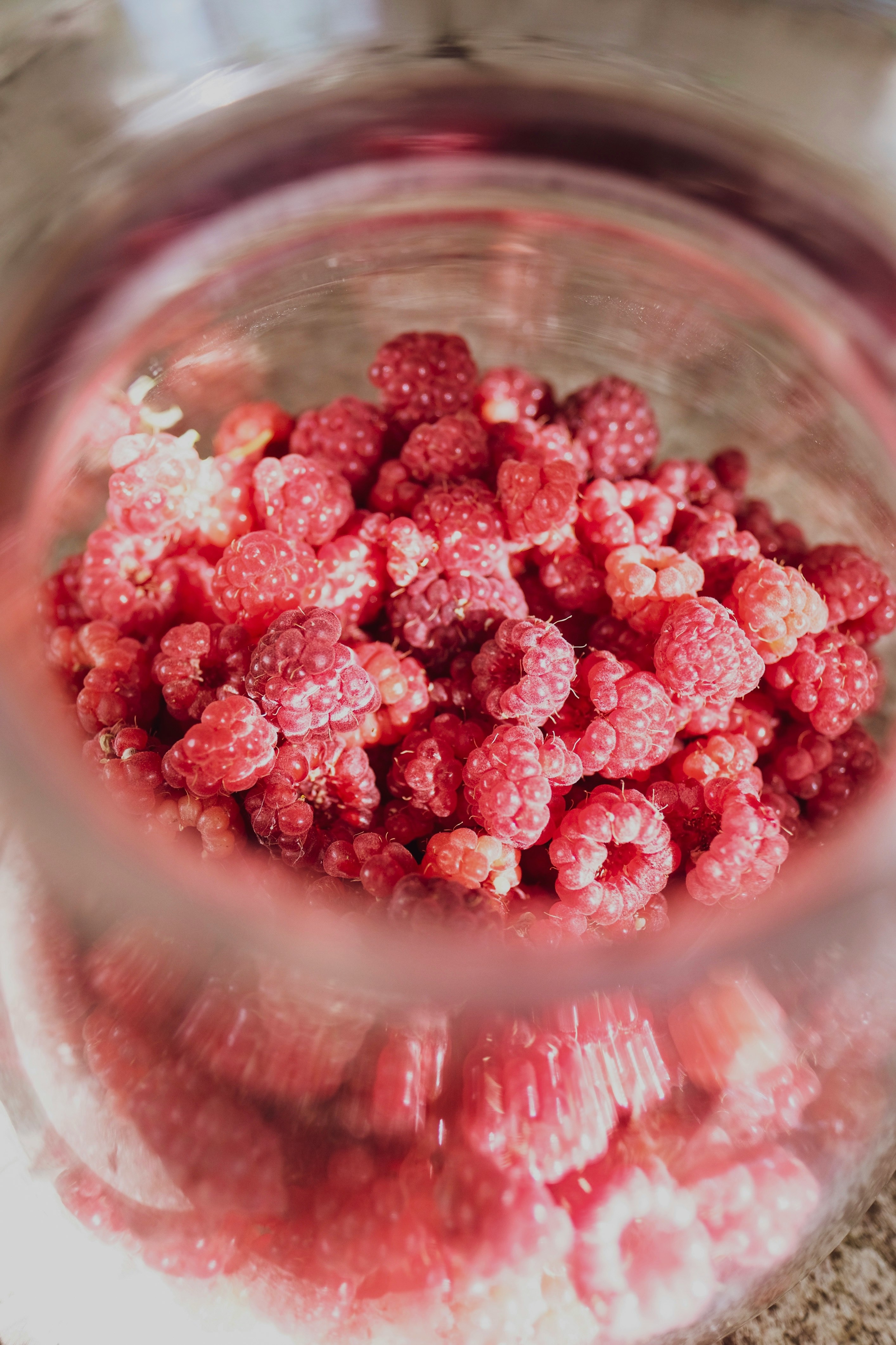 red round fruits in clear glass bowl